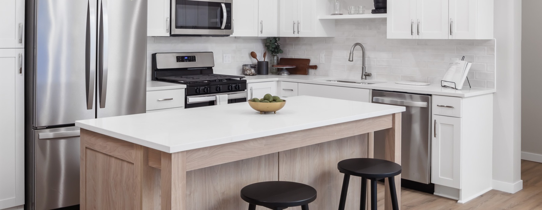 Modern apartment kitchen with a kitchen island in homes at Reserve at Mendota Village