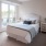 Large windows in carpeted apartment bedrooms at The Reserve at Mendota Village