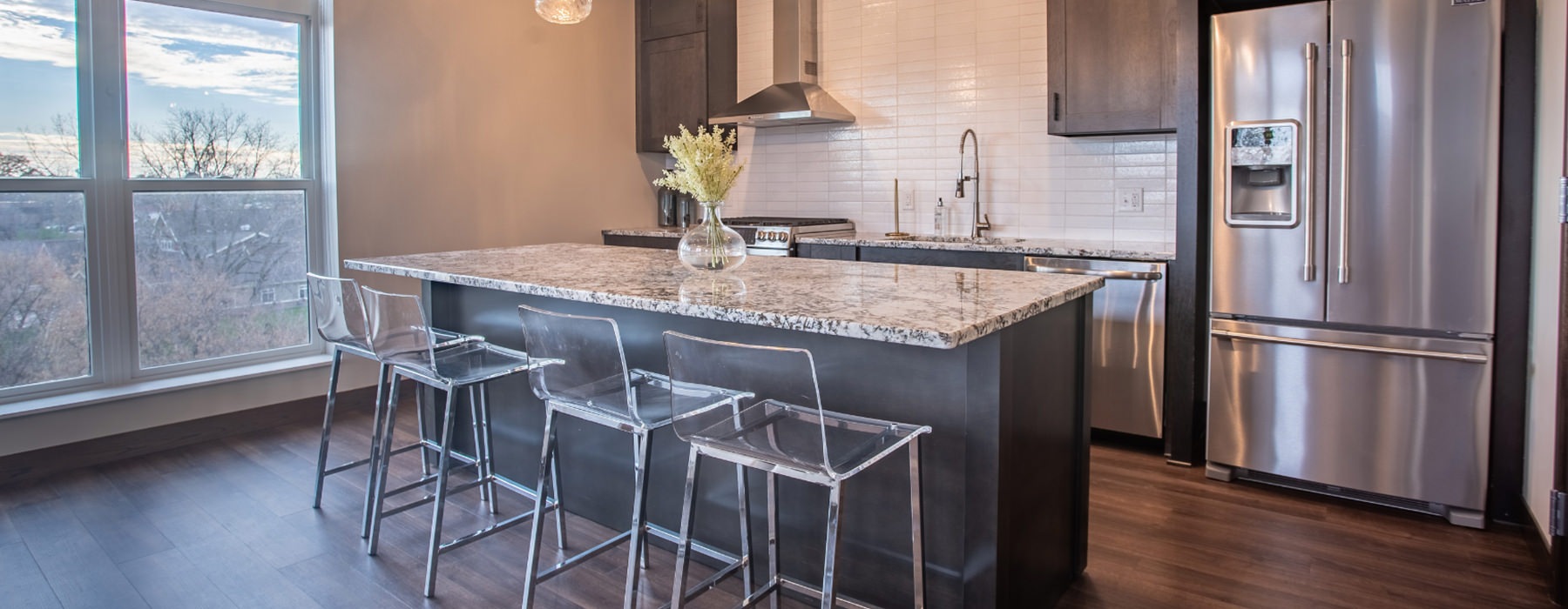 Spacious and well lit community room with ample seating at large windows 